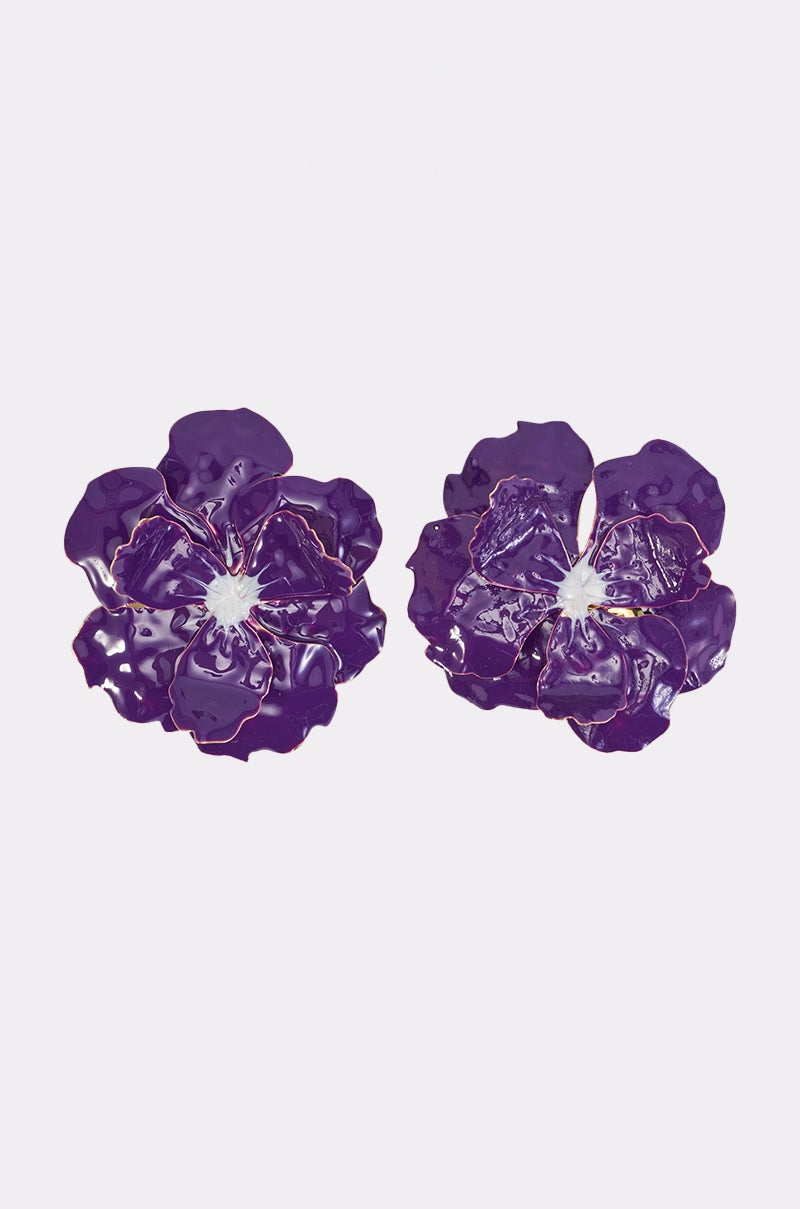 Two glossy, purple PURPLE HAZE FLOWER earrings with white centers are displayed on a plain, light background—perfect oversized accessories to elevate your party look.