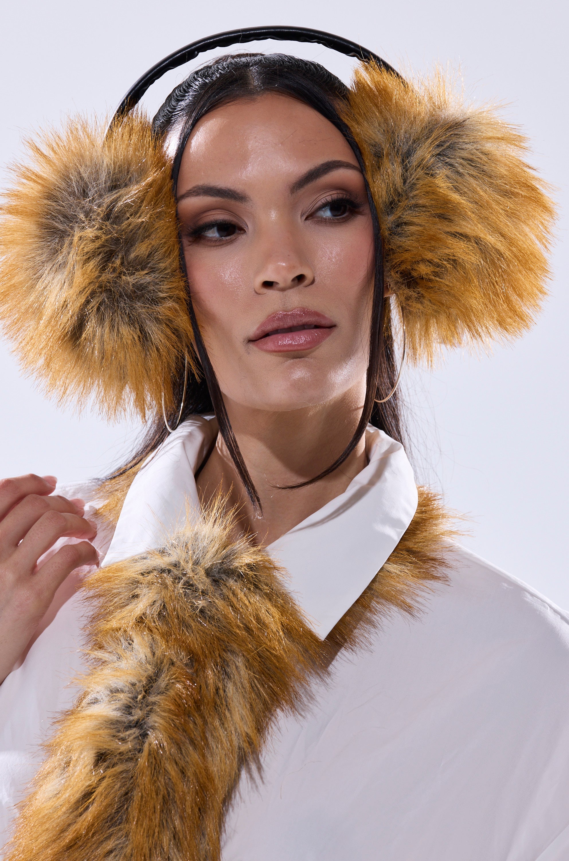 A woman wears REALLY LIKE THAT FAUX FUR EARMUFFS and a matching faux fur scarf over a white collared shirt, gazing softly to the side—an elegant and cozy winter accessory choice. 6
