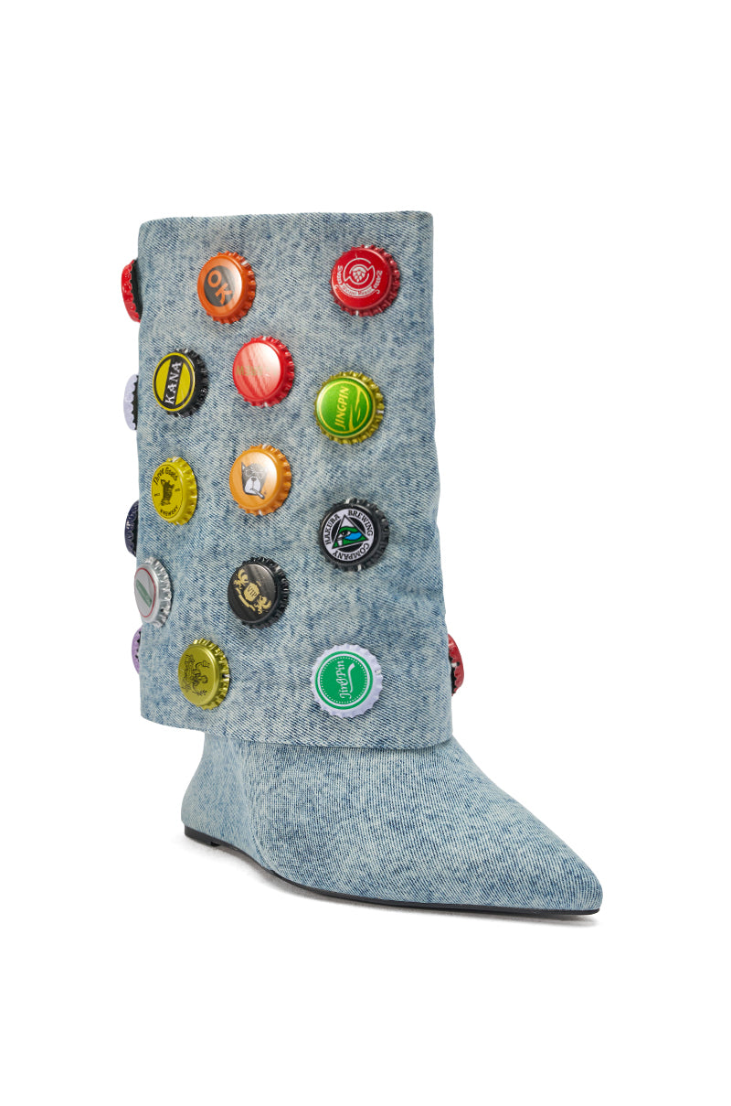 The AZALEA WANG EAVEN WEDGE EMBELLISHED DENIM BOOTIE is a light blue, denim-textured bootie with a pointed toe and colorful bottle caps decorating the shaft.