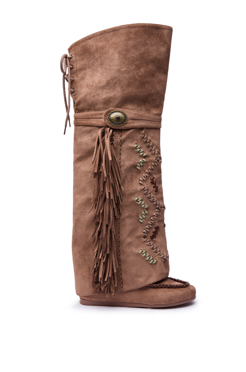 The AZALEA WANG EDMUND BROWN FLAT WESTERN BOOT features brown faux suede, fringe side accents, decorative stitching, a large button detail, and an open toe—all shown against a white background.