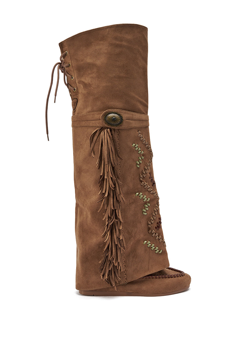 The AZALEA WANG EDMUND BROWN FLAT WESTERN BOOT is a brown faux suede knee-high boot with fringe accents, decorative stitching, a side button, top laces, and an open toe. 4