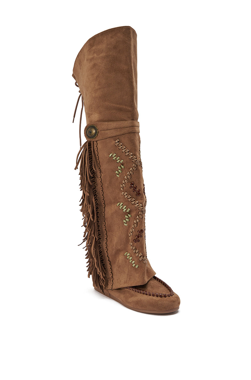 The AZALEA WANG EDMUND BROWN FLAT WESTERN BOOT is a knee-high brown faux suede boot featuring decorative stitching, outer fringe, a round button detail, and a soft sole for relaxed Western, bohemian style with unique charm. 5