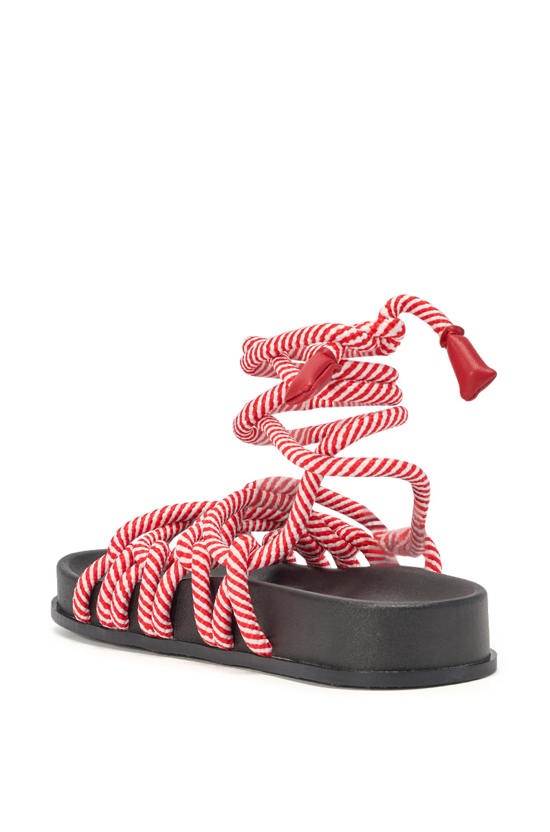 Step out in summer style with the AZALEA WANG EINER RED ROPE FLATFORM SANDAL, featuring a thick black sole and red-and-white twisted rope straps wrapping around the foot and ankle, finished with a red plastic tip. 6