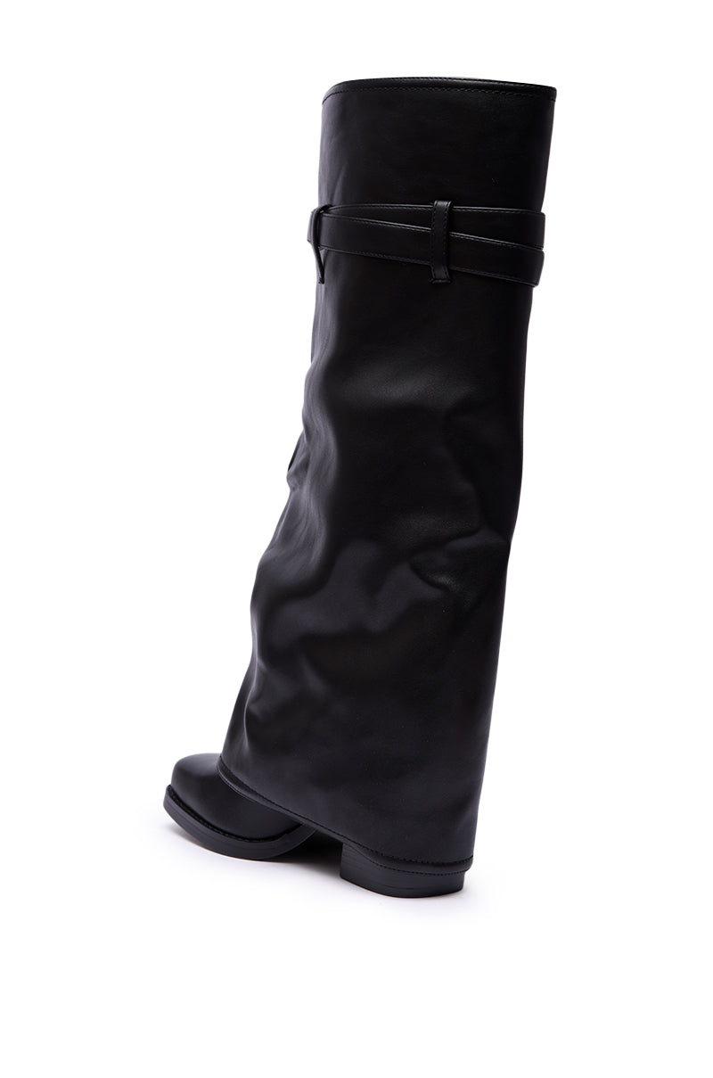 The AZALEA WANG EIRA CHUNKY BOOTIE WITH SQUARE TOE is a black, mid-calf leather boot featuring a slouchy silhouette, thin top strap, and modern square toe, shown from a rear side angle.