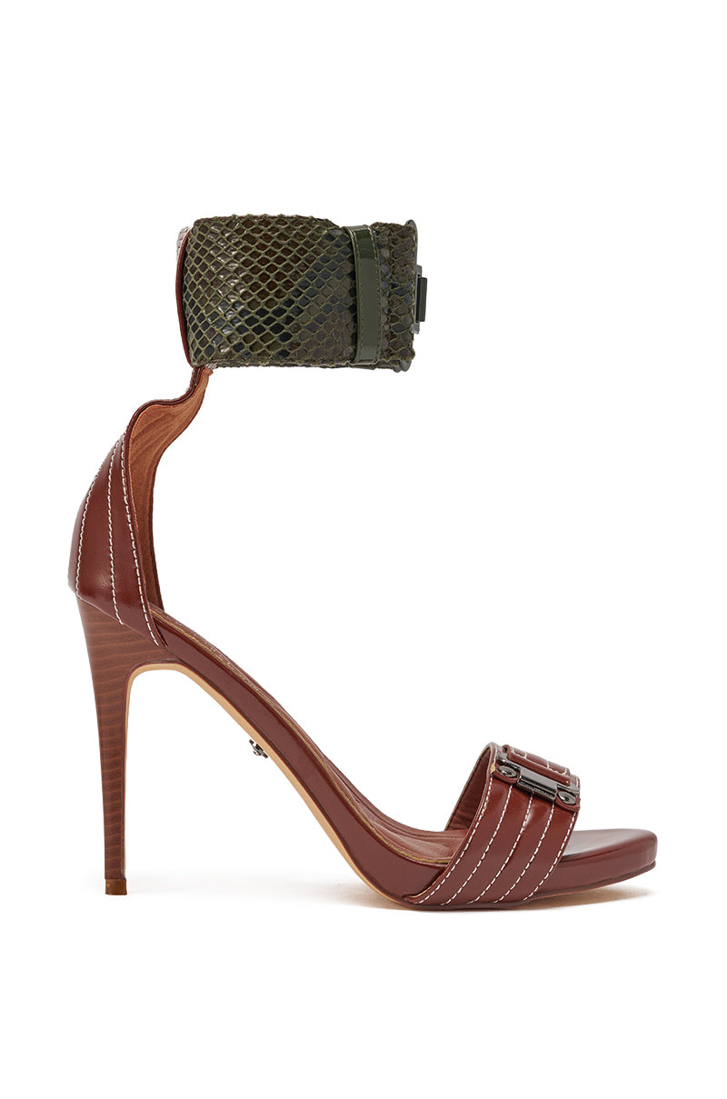 The AKIRA GOLD ELEGY BROWN CROC BUCKLE HARDWARE STILETTO SANDAL features a brown faux leather sole, stiletto heel, white stitching, open toe, buckle toe strap, and a wide green crocodile-embossed ankle cuff with clasp. 3