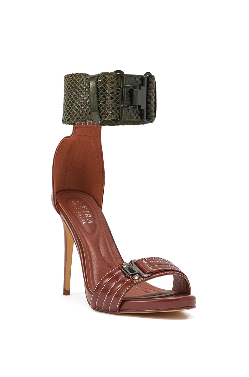 The AKIRA GOLD ELEGY BROWN CROC BUCKLE HARDWARE STILETTO SANDAL features a brown faux leather base, open toe, white stitching, and a wide green crocodile-embossed ankle cuff with buckle hardware and large clasp. 4
