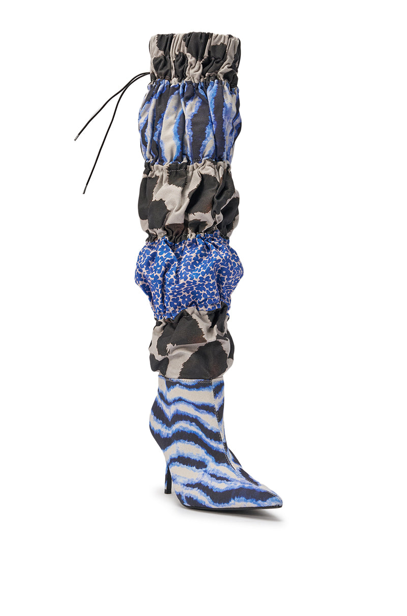 Make a statement in the AKIRA GOLD ELODIE BLUE MULTI PATCHWORK BOOT—over the knee, slouchy stilettos featuring a pointed toe, ruched shaft, and bold blue, black, gray, and white mixed patterns. 4