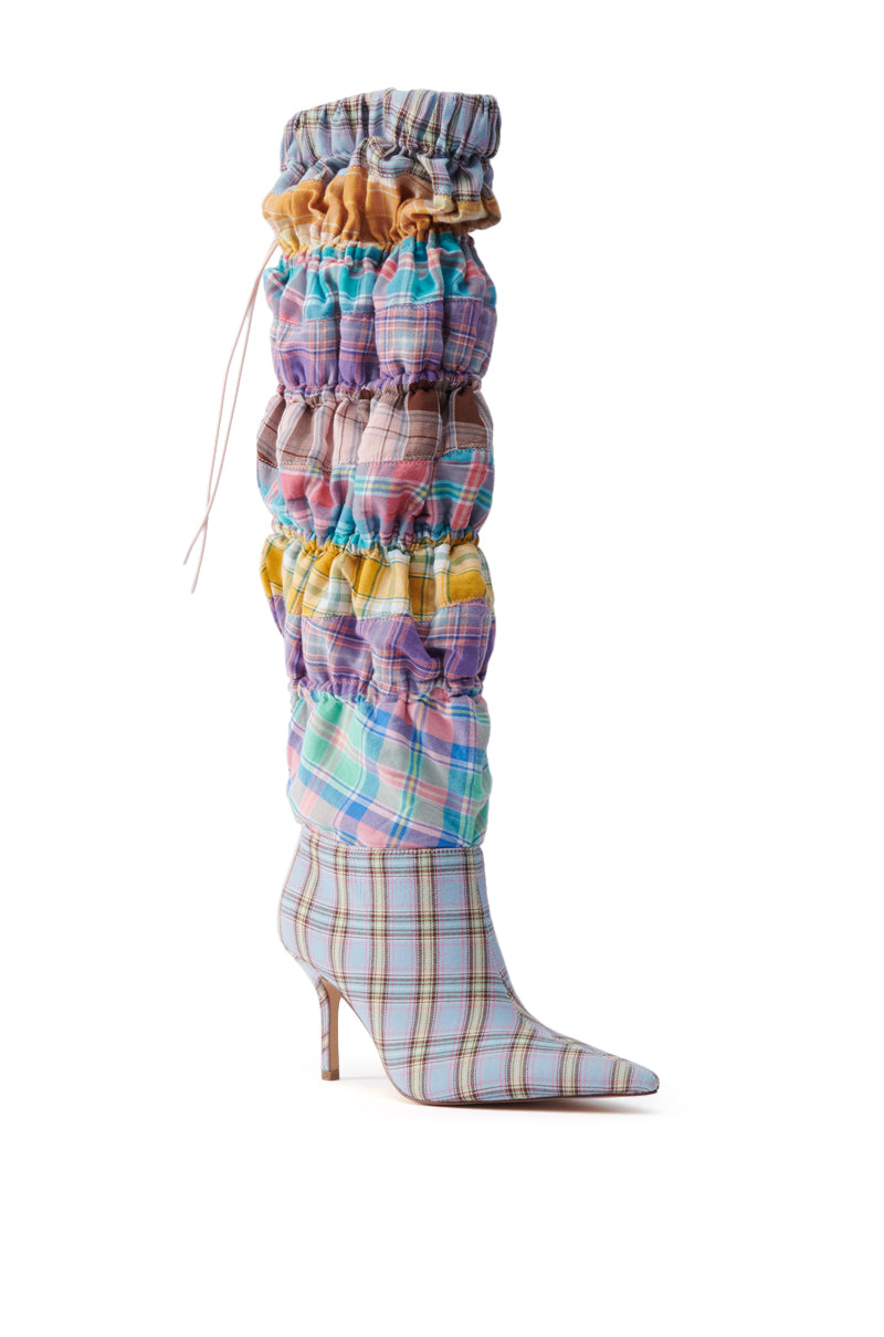 The AZALEA WANG ELODIE PINK MULTI BOXER BOOT is a knee-high stiletto with a pointed toe, featuring ruched pastel plaid fabric and layered, gathered details for a chic, textured style.