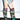A person in frayed denim shorts and tall, slouchy AZALEA WANG ELODIE PLAID MULTI FLANNEL STILETTO BOOTS with pointed heels stands indoors against a plain wall.