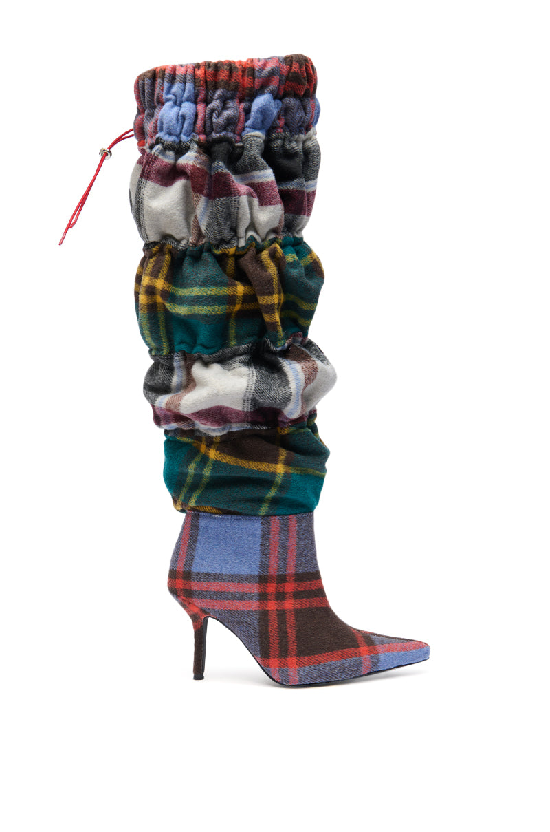 The AZALEA WANG ELODIE Plaid Multi Flannel Stiletto Boot is knee-high with a pointed toe, ruched multicolored flannel upper, slender high heel, and a stylish top drawstring for added flair.