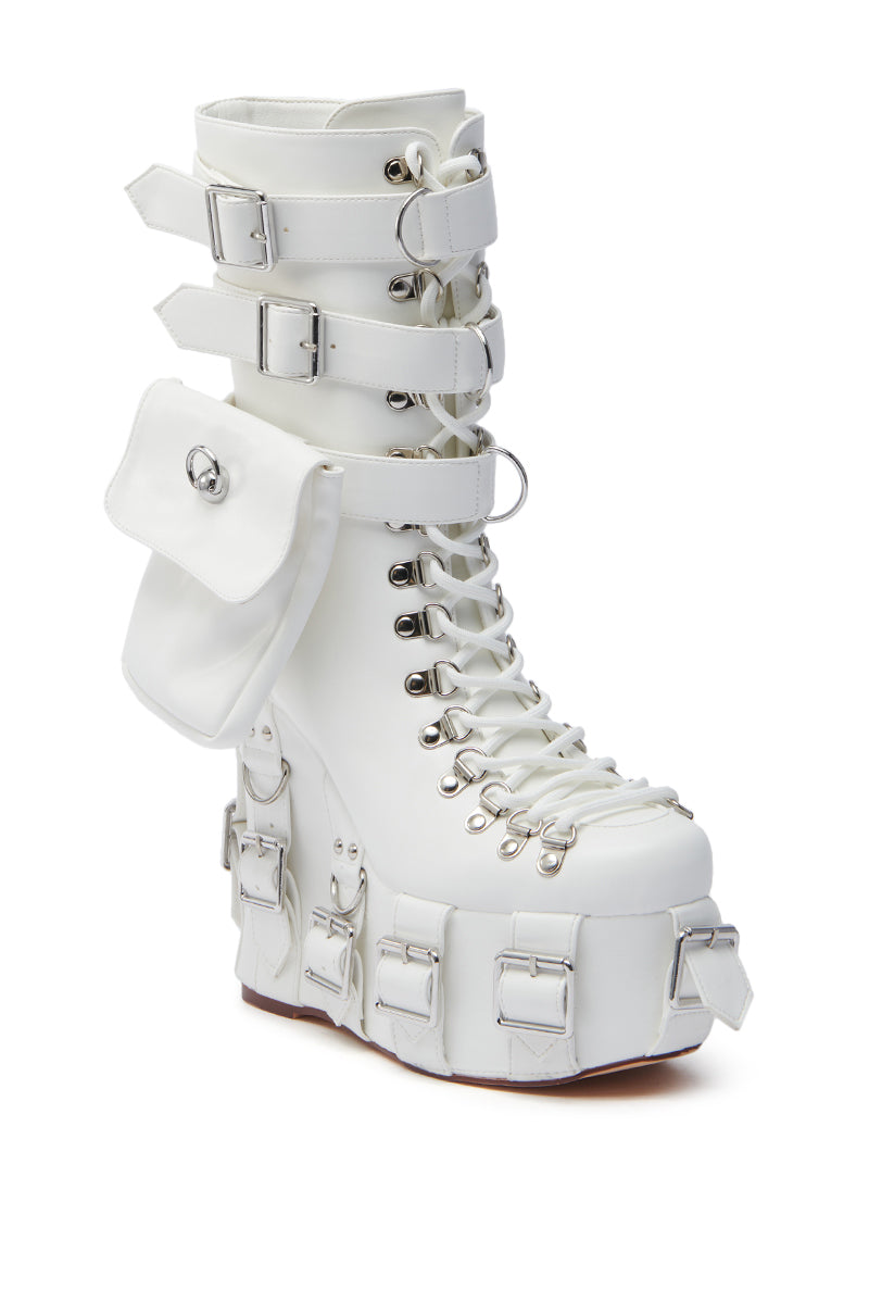The AZALEA WANG ELOWYN WHITE EDGY WEDGE BOOT features a white faux leather design with decorative buckles, a lace-up front, a side pocket, silver hardware, and a chunky heel for a bold look.