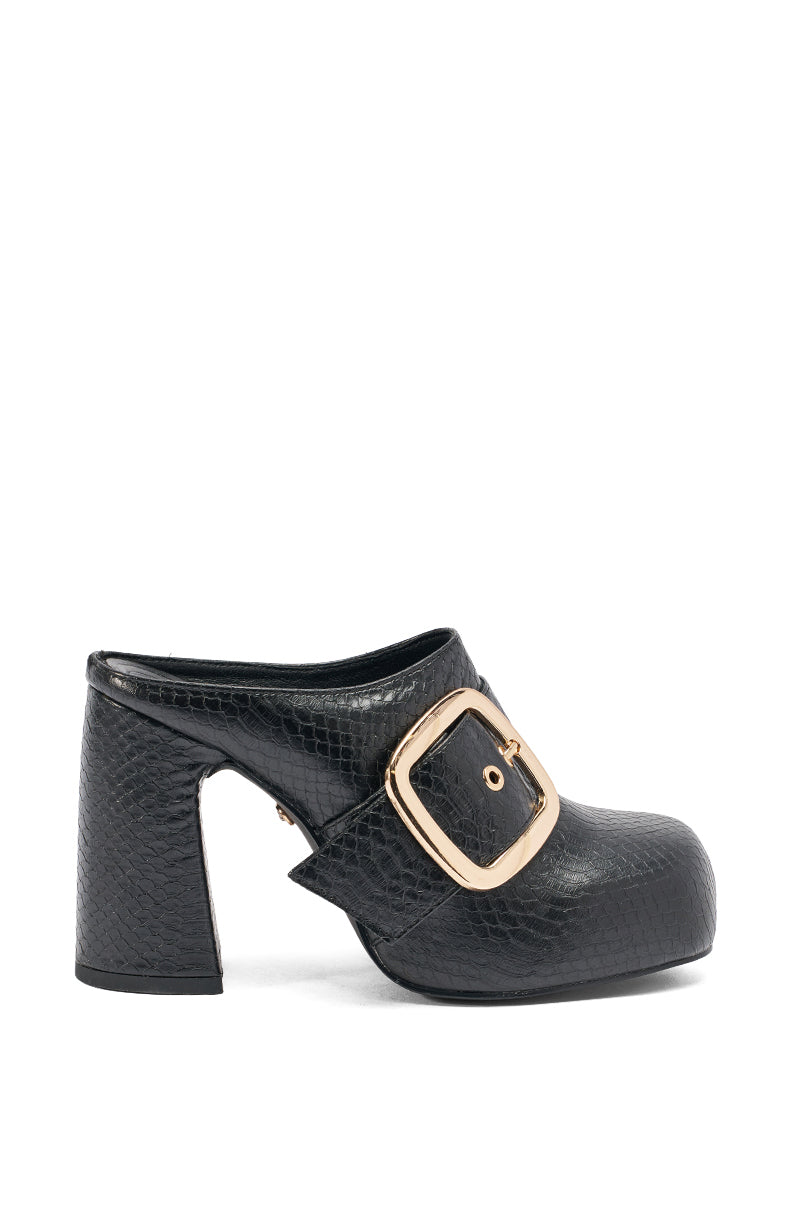 The AZALEA WANG ELYSIA BLACK PU ROUND TOE MULE is a black faux leather mule with a chunky heel, snakeskin texture, and bold gold buckle detail, shown against a white background. 3
