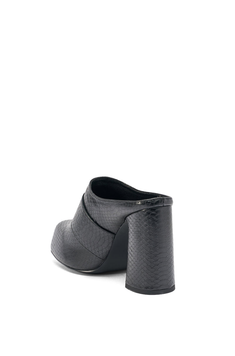 The AZALEA WANG ELYSIA BLACK PU ROUND TOE MULE is shown from the back and slightly to the side, highlighting its crocodile-print black PU finish and high chunky heel against a plain white background. 5