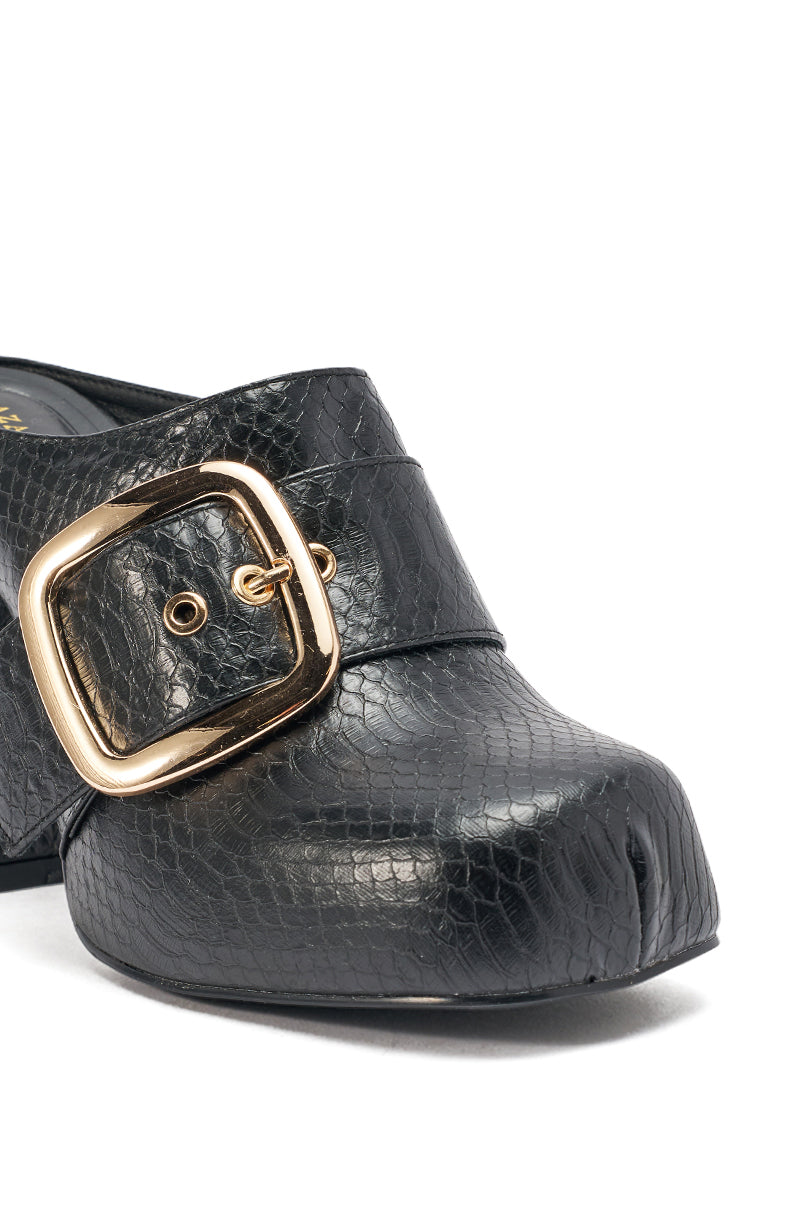 Close-up of the AZALEA WANG ELYSIA BLACK PU ROUND TOE MULE, featuring chunky black faux leather with a subtle snakeskin pattern, a large shiny gold side buckle, and a stylish squared toe. 7