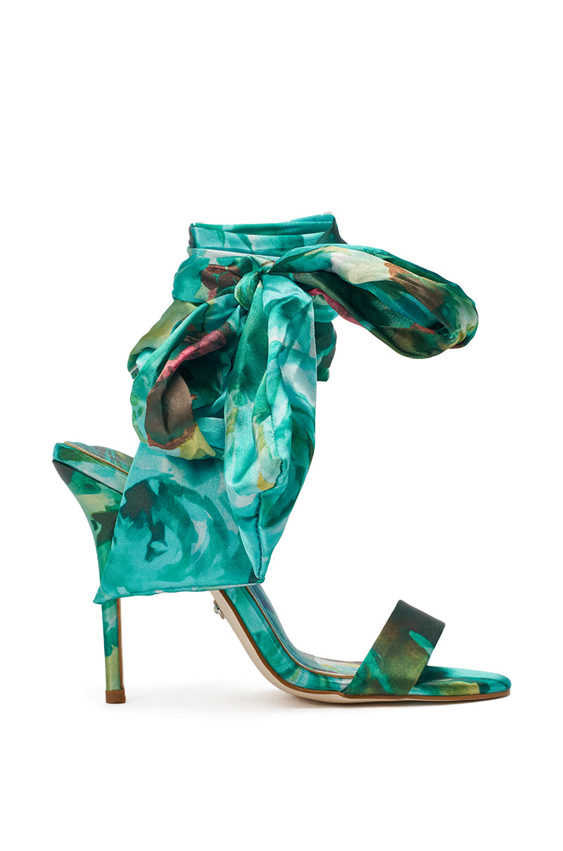 The AZALEA WANG ELZON Green Satin Strappy Sandal features a green multi-tone satin finish, floral pattern, stiletto heel, open toe, single front strap, and a large bow-like ankle wrap. 3