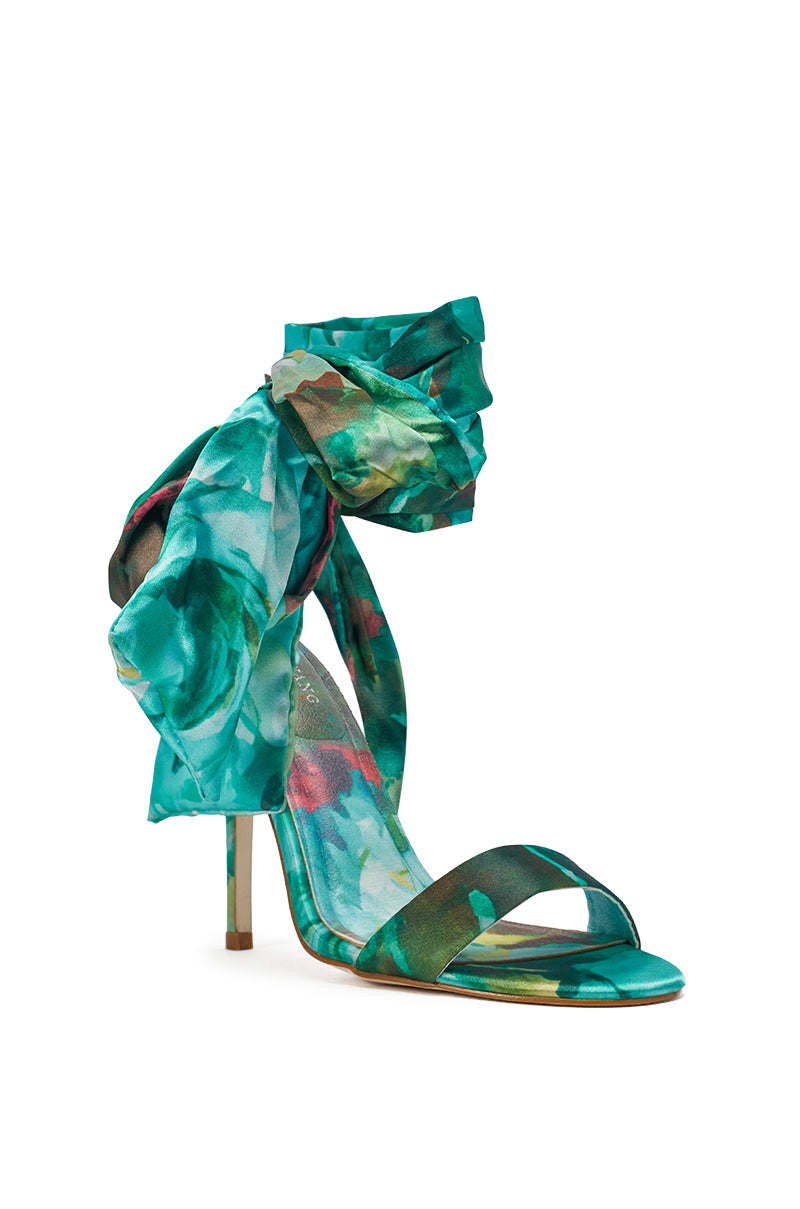 The AZALEA WANG ELZON GREEN SATIN STRAPPY SANDAL features a turquoise floral design, ankle strap with dramatic fabric bow, open toe style, and slim green stiletto heel for a striking look. 4
