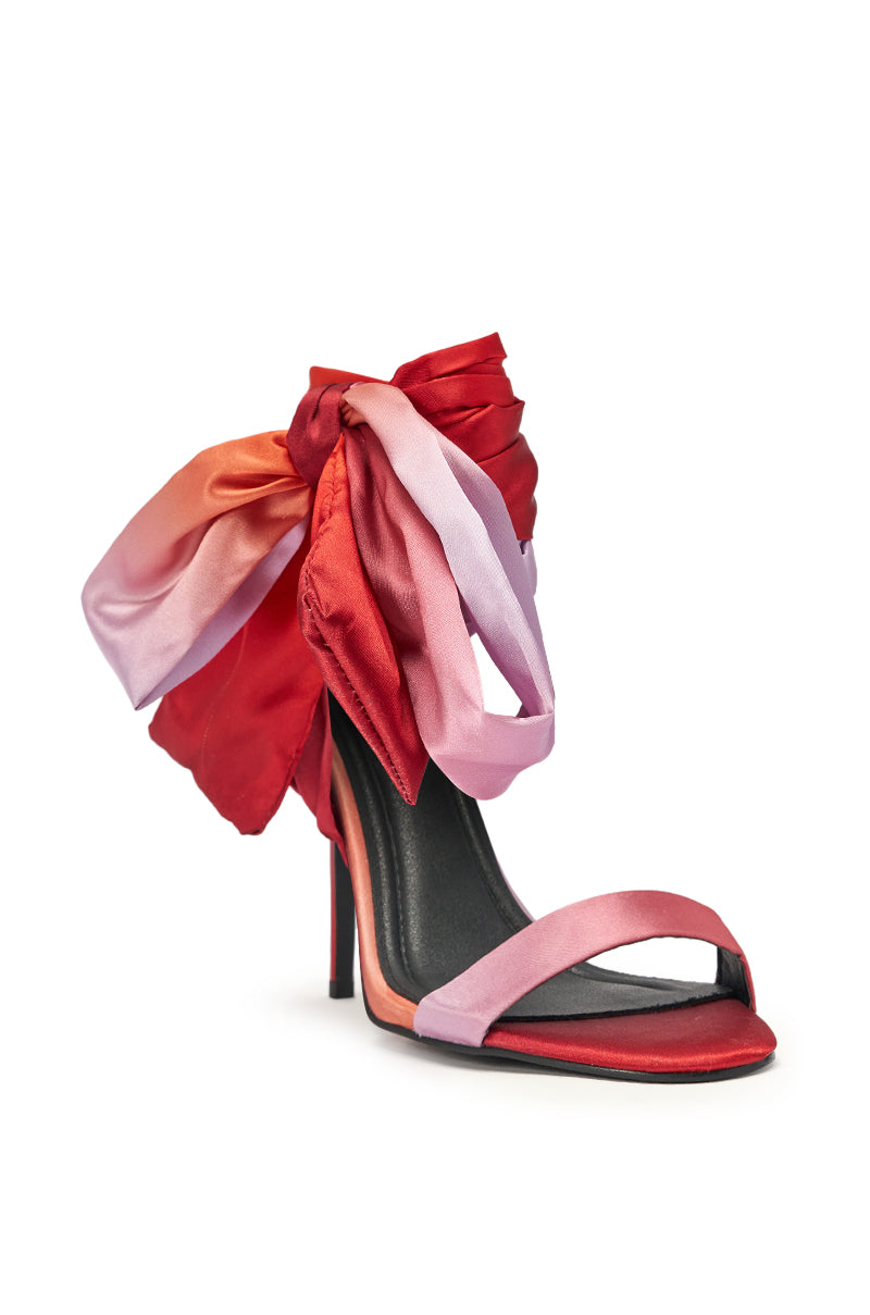 The AZALEA WANG ELZON ORANGE SATIN STRAPPY SANDAL showcases a slim high heel, open toe, vibrant pink and red satin straps, and a bold ombré bow in red, pink, and orange wrapping the ankle—perfect for evening parties. 6