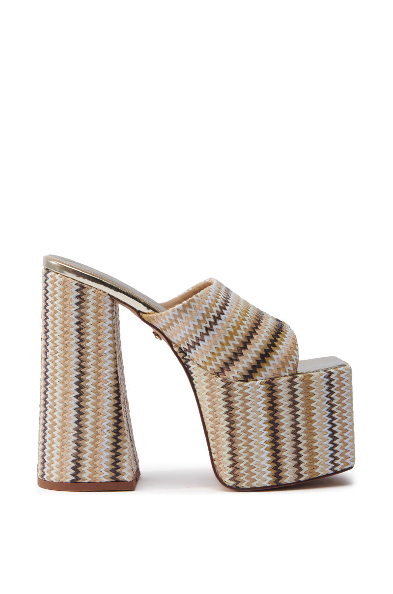 Side view of the AZALEA WANG EMBERS BROWN CHUNKY PLATFORM SANDAL, featuring an open square toe with a zigzag pattern in beige, brown, and cream. The chunky heel and platform enhance the intricate raffia upper.