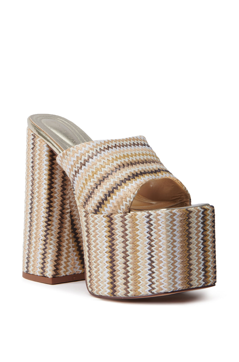 The AZALEA WANG EMBERS BROWN CHUNKY PLATFORM SANDAL has a multicolored zigzag pattern in beige, brown, and white. It features an open square toe and a wide front strap with a textured raffia upper for a striking look.