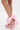 A person wears the AZALEA WANG EMEKA Pink Platform Sandal with Bow, featuring large matching ankle bows, a stylish wedge heel, and faux leather construction, standing on a white background.