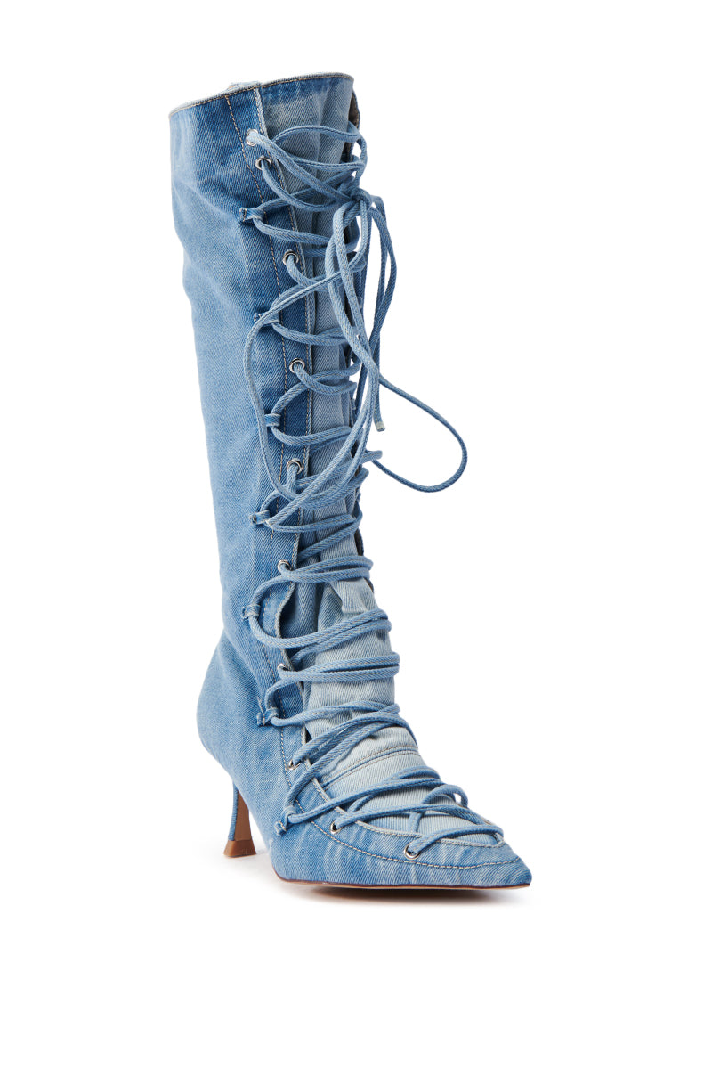 The AZALEA WANG EMMALINE DENIM STILETTO BOOT features intricate laces from toe to knee, a pointed toe, and a slender heel, blending casual denim with chic style.