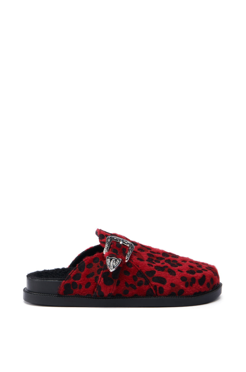 The AZALEA WANG ENDGAME RED LEOPARD slip-on shoe features a bold red leopard print with a faux pony hair texture. It is accentuated by a metal buckle detail and complemented with a black sole, showcasing an ideal mix of casual style and striking design in its side profile.