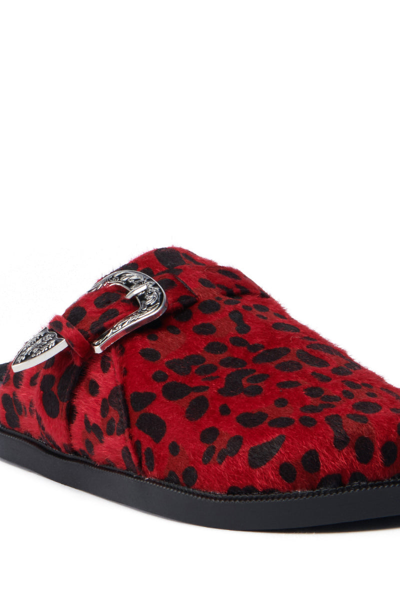 The AZALEA WANG ENDGAME RED LEOPARD loafer showcases a vibrant red leopard print on luxurious faux pony hair, highlighted by a decorative silver-tone buckle on the side. It is finished with a sleek black sole, making it a bold statement piece.