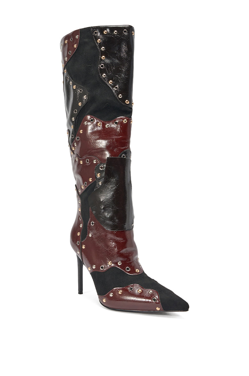 The AKIRA GOLD ENYAE MAHOGANY MULTI PATCHWORK STILETTO BOOT features knee-high, pointed-toe style in black, burgundy, and dark red faux leather with silver grommets accenting its color block patchwork design. 3