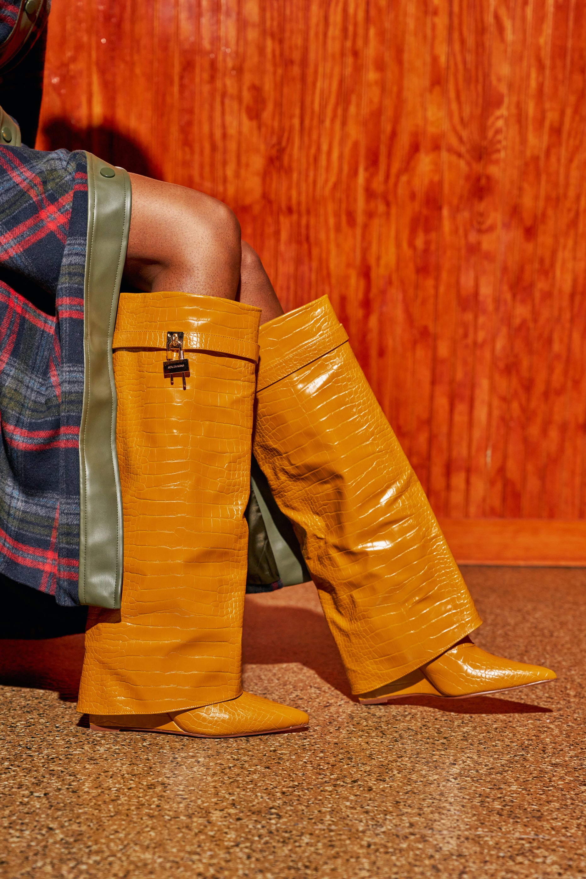 AZALEA WANG ENZO MUSTARD CROC SHARK BOOT: mustard crocodile-embossed pointed-toe boots featuring a wide, folded cuff and a small padlock detail.