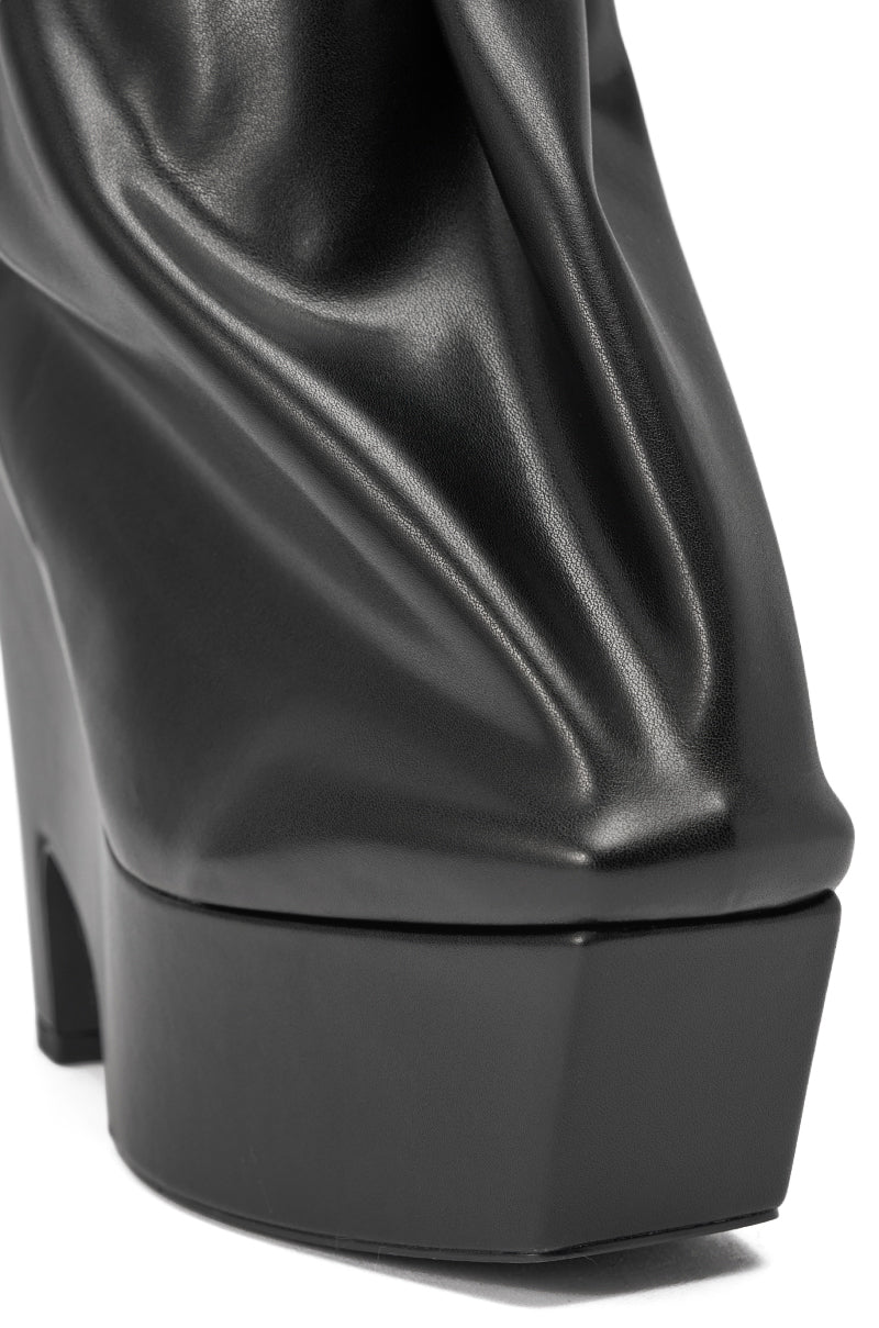 Close-up of the AKIRA GOLD EPIGRAM PU SLOUCH CHUNKY HEEL BOOTIE, featuring a black square toe, wrinkled shiny upper, and bold platform sole. 6