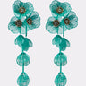 The TOTEALLY EARRING is an oversized floral pair shaped like flowers and leaves, featuring intricate wire details and gemstone-centered clusters of small beads, showcased on a plain white background for a striking botanical effect.