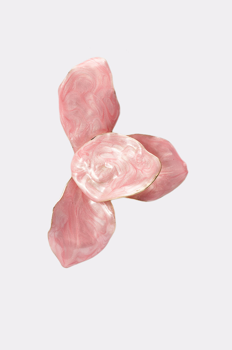The PRETTY IN PINK EARRING features three petal-shaped, marbled pink enamel pieces with a glossy finish, arranged in a circle on a plain light gray background. 5