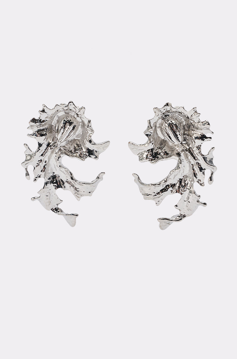 MOLTEN WAVE STATEMENT EARRINGS: Silver sculptural earrings featuring an abstract, swirling wave design with textured, hammered details, displayed on a plain white background.