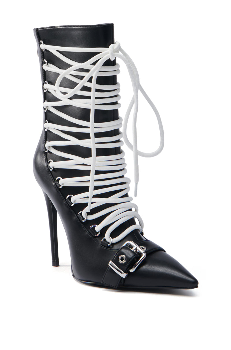 AZALEA WANG ERYX Black Lace Up Stiletto Bootie in faux leather has a pointed toe, white lace-up design, decorative silver buckle near the toe, side zipper closure, and stylish crisscross laces.