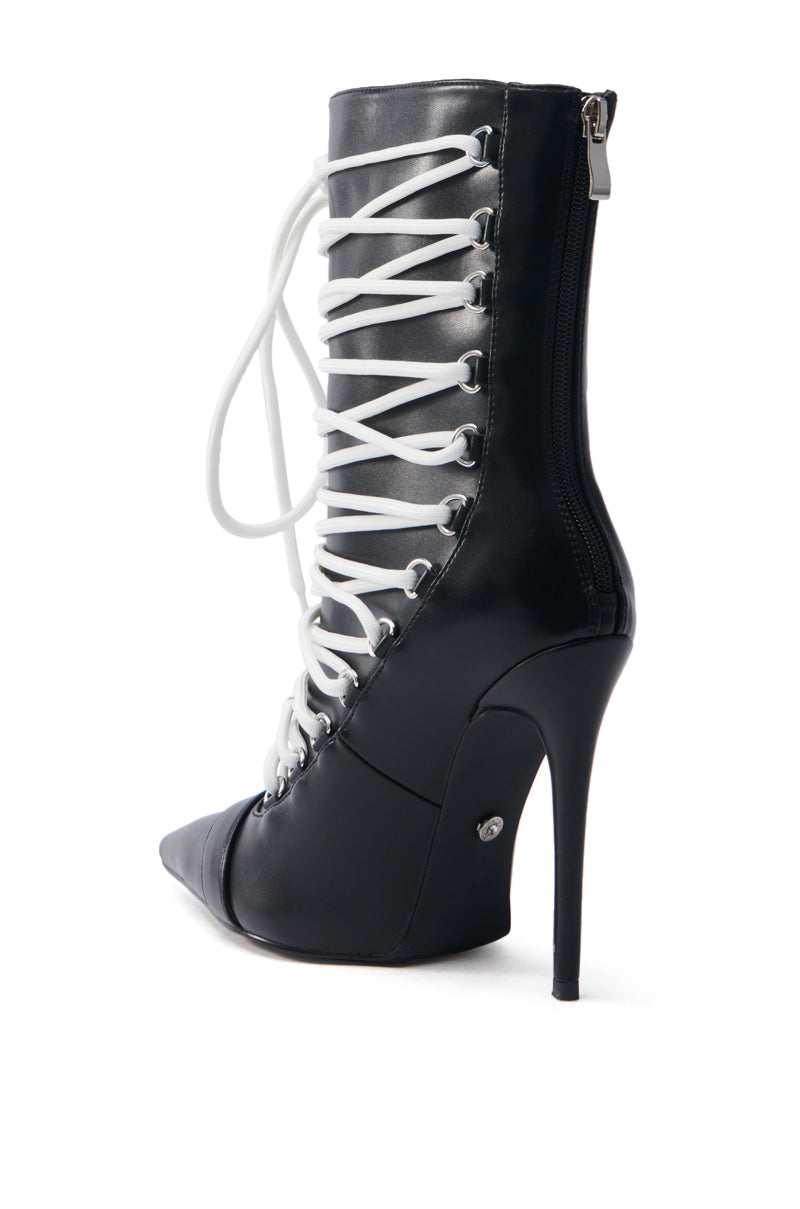 The AZALEA WANG ERYX Black Lace Up Stiletto Bootie is crafted in faux leather, featuring a pointed toe, white laces, and a sleek side zipper for a blend of classic elegance and modern style.
