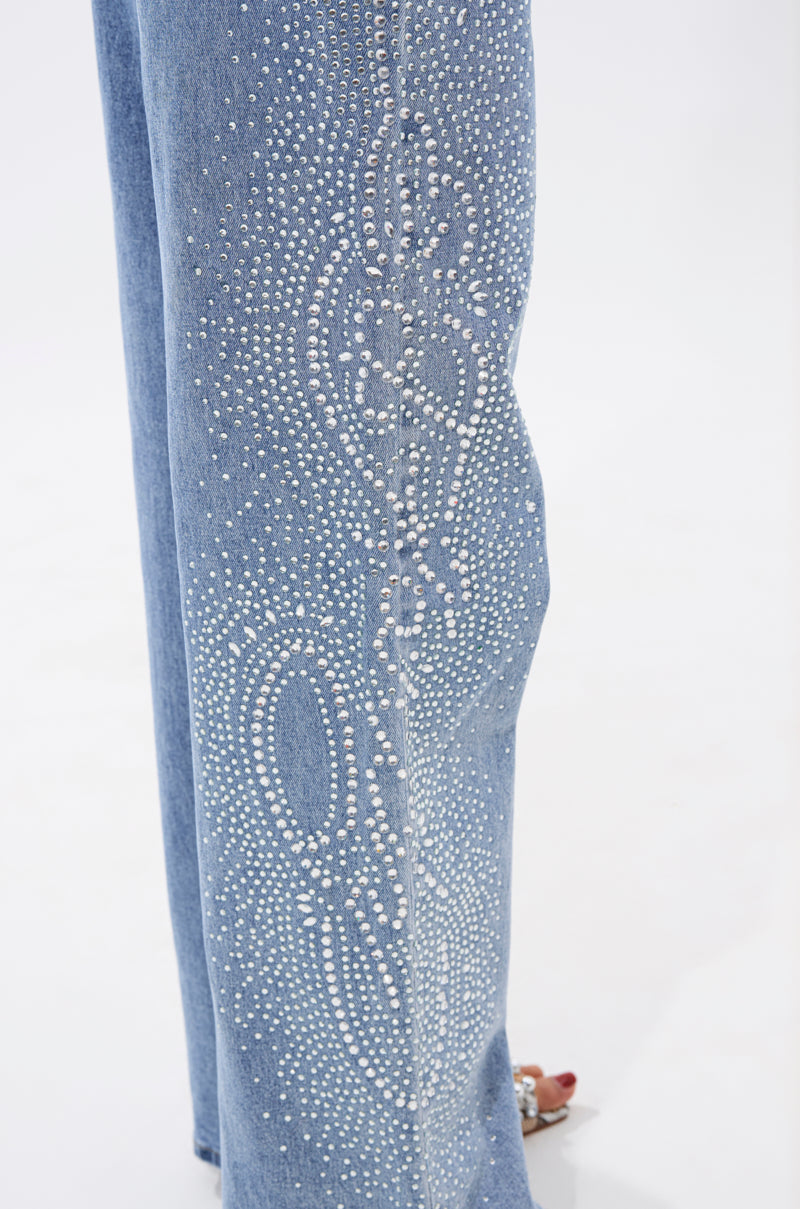 Close-up of the DREAMING OF YOU WIDE LEG DENIM in light blue, showing a detailed pattern of small rhinestones running vertically along the wide leg against a plain white background. 7