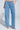 Wearing TAKE ME OUT RHINESTONE DENIM JEANS with a diamond-shaped rhinestone pattern, paired with a glittery handbag and heeled sandals for added sparkle.