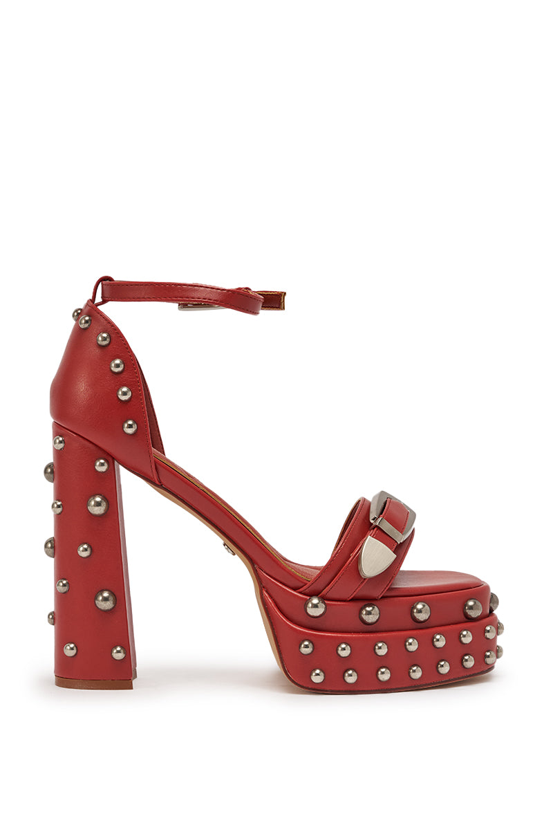 The AZALEA WANG EUGENIJA red chunky embellished studded sandal features faux leather, a wide front strap with a large silver buckle, an ankle strap with buckle closure, and a platform heel. 4