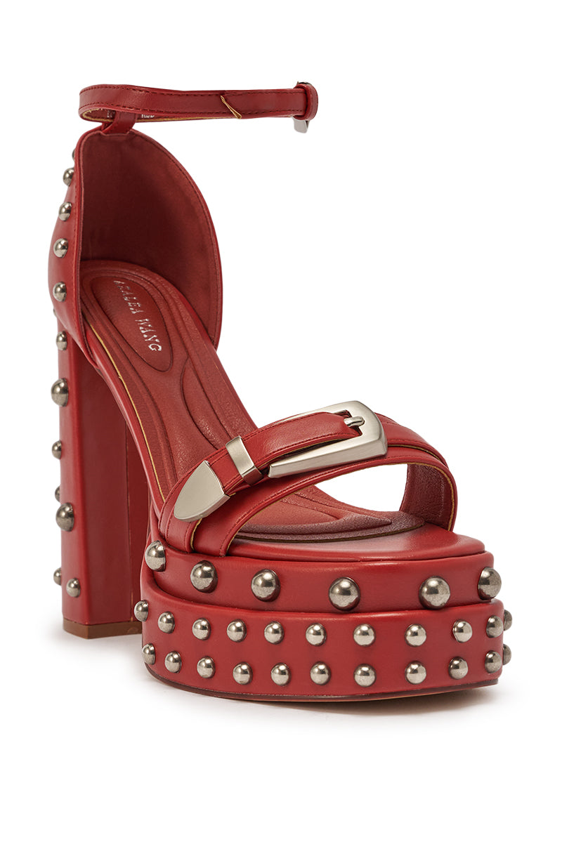 The AZALEA WANG EUGENIJA Red Chunky Embellished Studded Sandal features burnt red faux leather, silver studs, a chunky platform heel, an ankle strap, and a large silver buckle on the front strap. 5
