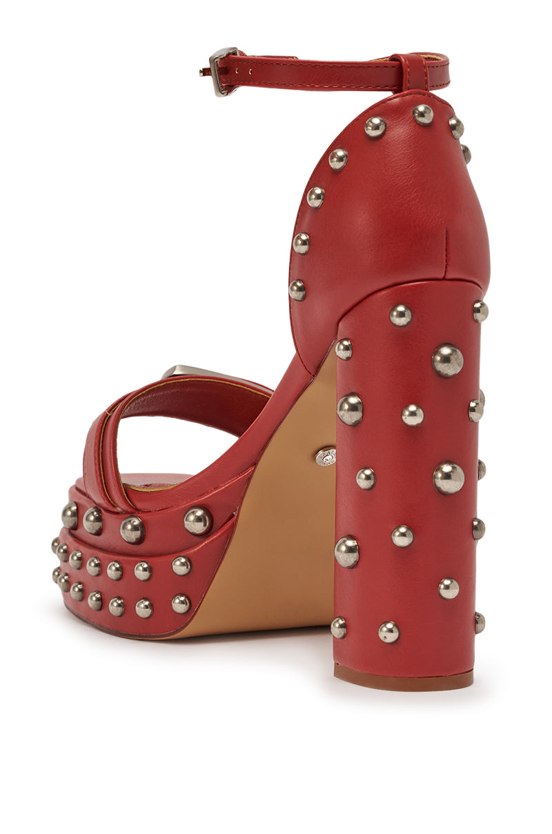 The AZALEA WANG EUGENIJA RED CHUNKY EMBELLISHED STUDDED SANDAL features faux leather, a platform heel, an ankle strap, and bold silver studs decorating the tan sole and thick heel. 6