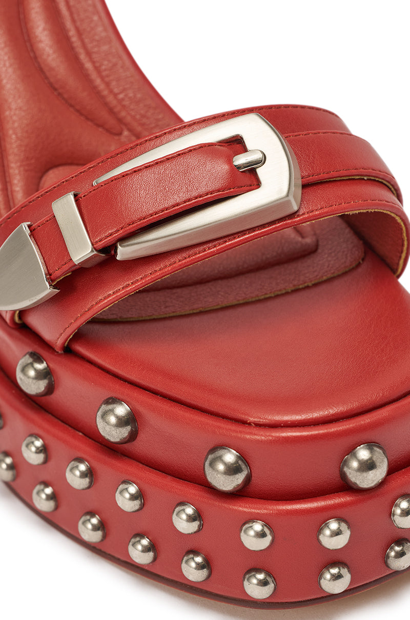 Close-up of the AZALEA WANG EUGENIJA RED CHUNKY EMBELLISHED STUDDED SANDAL in burnt red faux leather with metal studs, a silver buckle, and a chunky platform heel. 8
