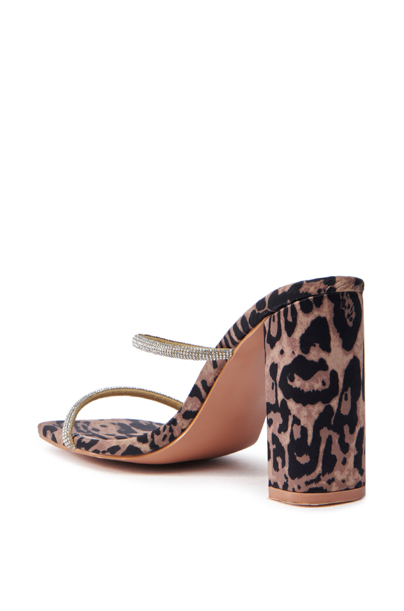 The AZALEA WANG Eulalia leopard slip-on sandal features a chunky block heel and two thin, rhinestone-encrusted straps, beautifully displaying both its side and back.
