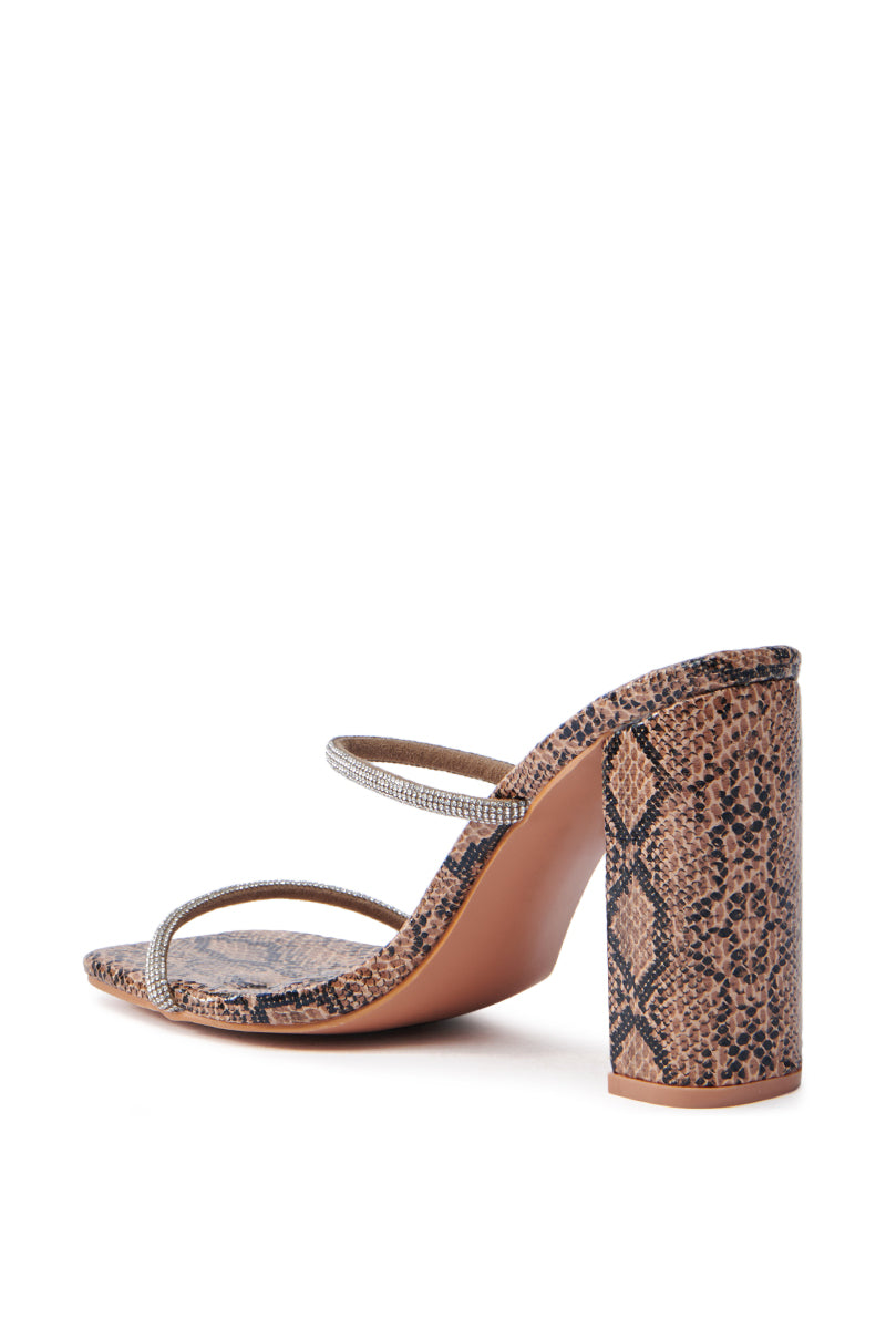 The AZALEA WANG Eulalia Snake Slip On Sandal features a chic brown and black snake print with rhinestone straps over the toes and a chunky block heel. The artistic back-side view enhances its elegance.