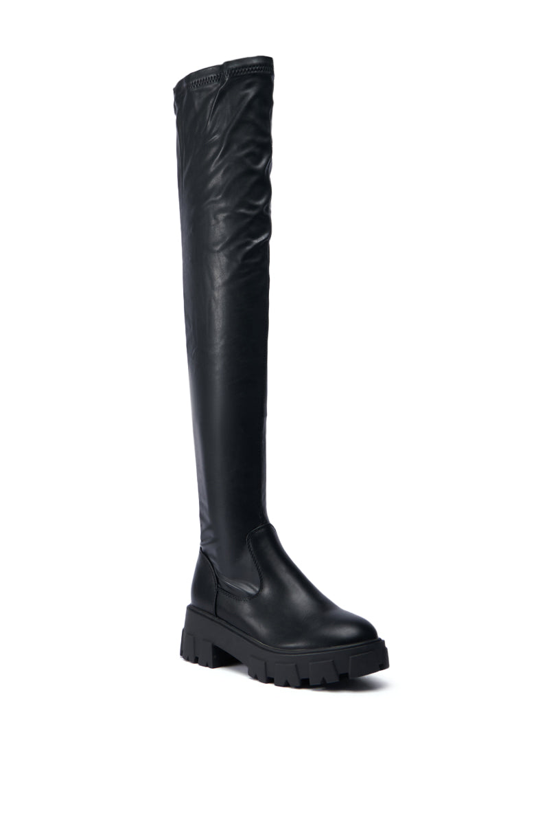 Product Description: The AZALEA WANG EUREVA BLACK FLAT BOOT is a black over-the-knee boot featuring a chunky sole and smooth faux leather finish. It boasts a thigh-high shaft, sturdy design, rounded toe, and seamless shaft extending above the knee.