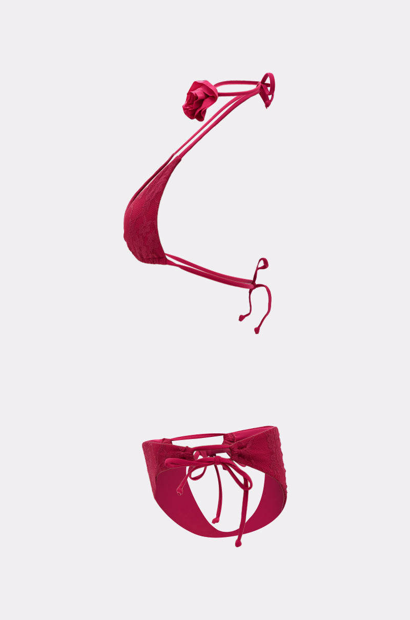 The MY ROSE SWIM SET features a red lace overlay with a halter neck bra, thin straps, bow detail, and matching panties with a keyhole back and ribbon ties, displayed on a light background.