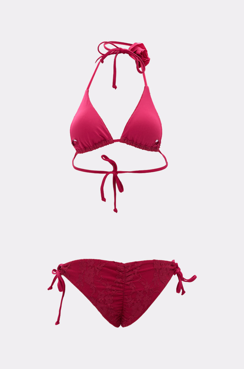 The MY ROSE SWIM SET is a two-piece red bikini with a halter neck tie top and tie-side bottoms, featuring a simple design and subtle textured detailing on the bottoms.