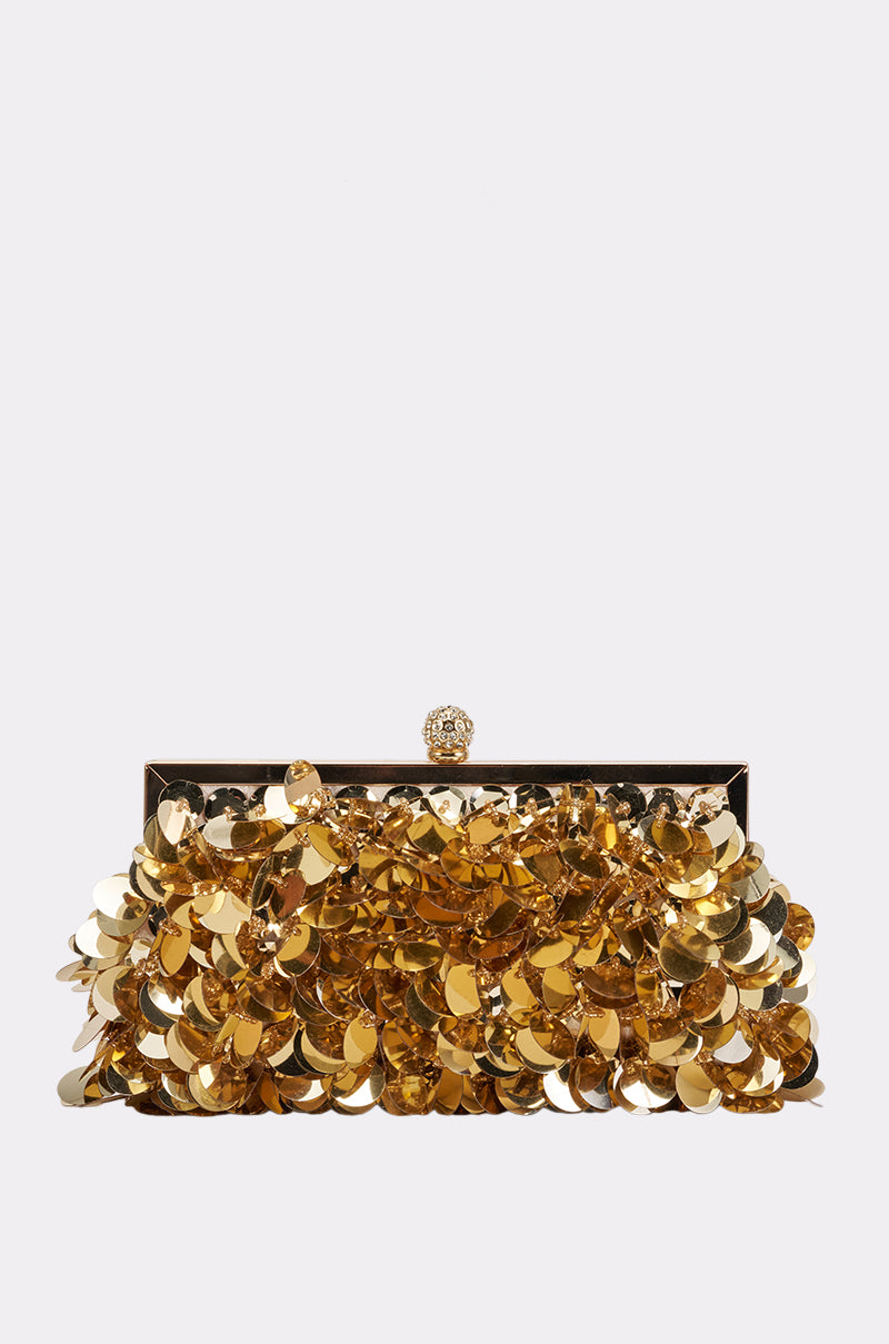 Introducing the GOLDEN AGE CLUTCH, a rectangular gold sequin clutch featuring sparkling sequins and a dazzling jeweled clasp, showcased against a plain light gray background.