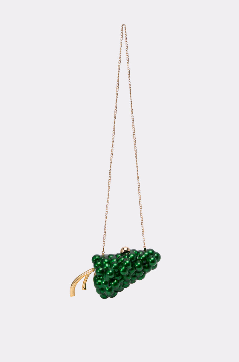 The I FEEL GRAPE CLUTCH, shaped like a bunch of green grapes, has a marbled high-shine acrylic finish, gold leaf accents, and a detachable gold chain strap, shown against a plain light background. 4