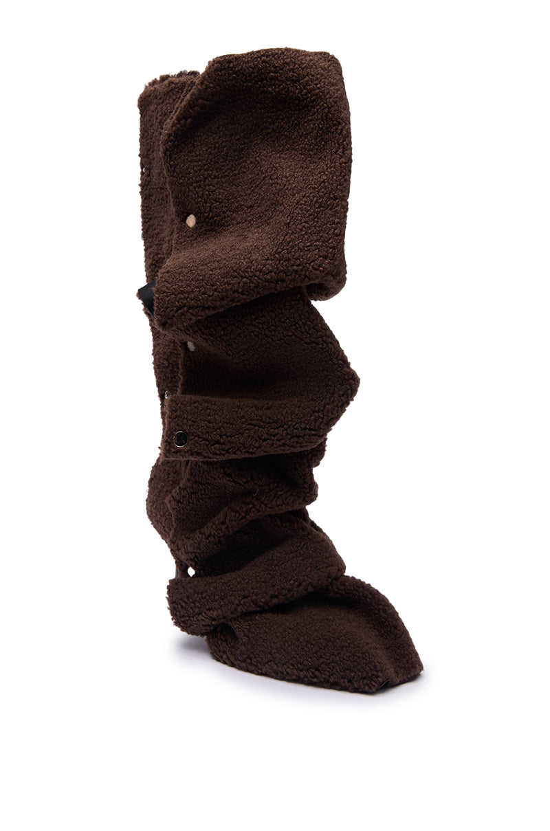 The AZALEA WANG FABIAN BROWN SHERPA FOLDED DETAIL BOOT, featuring a tall fleece texture, abstract slouchy ruched design, and snap button details, is shown against a plain white background.
