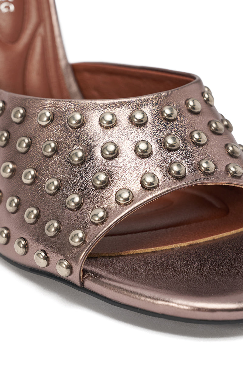 Close-up of the AZALEA WANG FABRON PEWTER EMBELLISHED WEDGE SANDAL with an open toe, pewter metallic finish, rows of round silver studs, brown interior, and black sole. 7